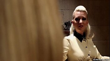 Big tits dominatrix Cherry Torn in latex suit runs the premiere dungeon and welcoms new domme Mona Wales for lesson and canes and toys her in bondage