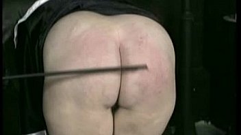 Bend over nun is spanked on her ass and hands with a wooden stick by priest