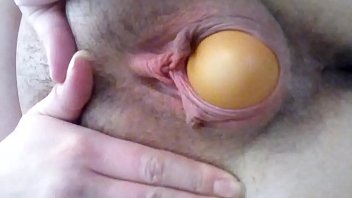 Sexy girl laying, and playing with, eggs in her pussy....