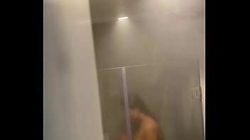 Pretty girl taking shower in hostal