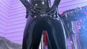 Miss Priest in her shiny black latex suit